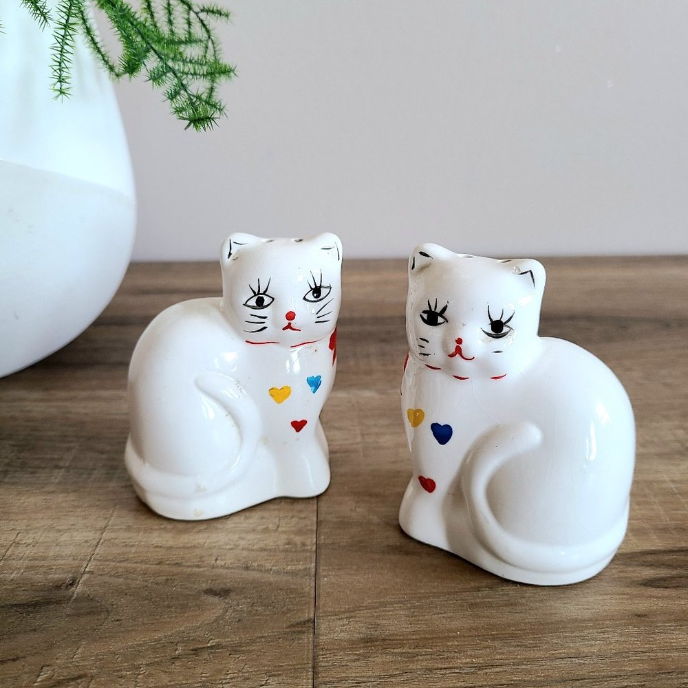 2 white cats with bows and hearts design salt & pepper shakers.